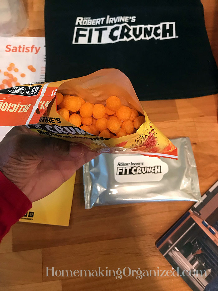 Getting a close up of the FITCRUNCH Cheddar Cheese High Protein Puffs